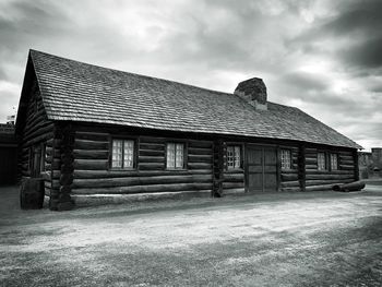 Old house on field against sky