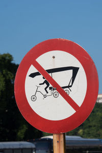 Close-up of road sign against clear blue sky