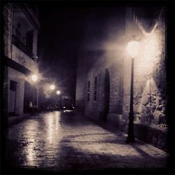 Illuminated street lights in city at night