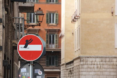 Road sign against buildings in city