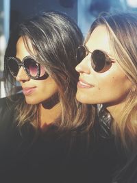 Close-up portrait of young woman wearing sunglasses