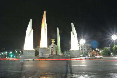 Illuminated church by street against sky at night