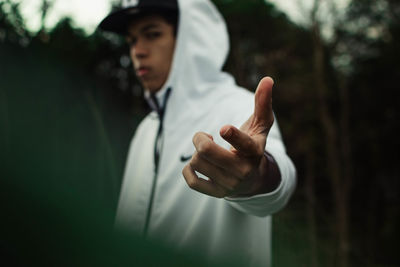 Portrait of young man standing against blurred background