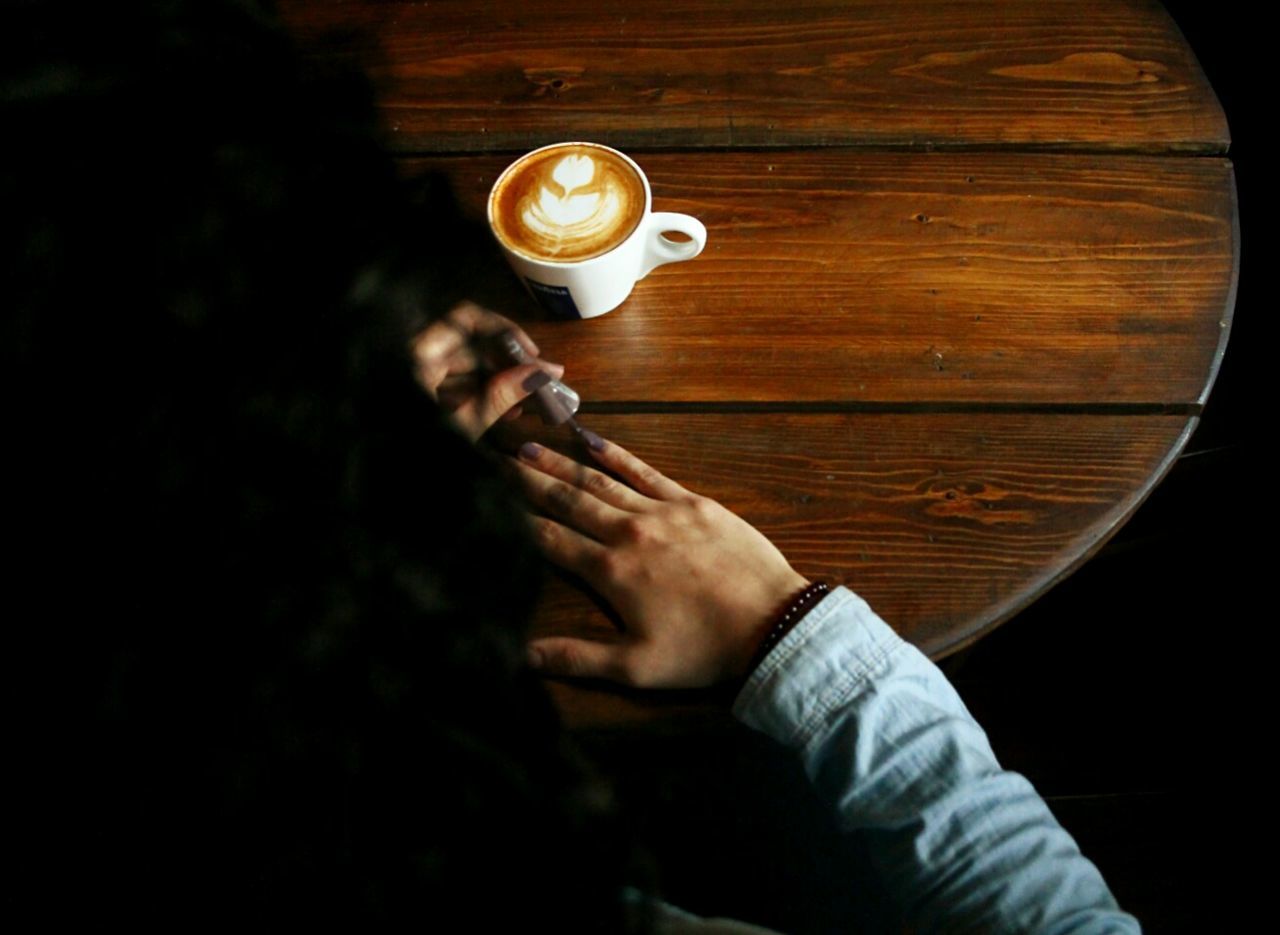 indoors, holding, person, lifestyles, leisure activity, men, drink, refreshment, food and drink, part of, wood - material, close-up, table, high angle view, unrecognizable person, human finger, cropped