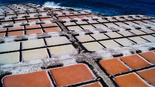 High angle view of salt flat sea salk farm water fields multicolour texture background 