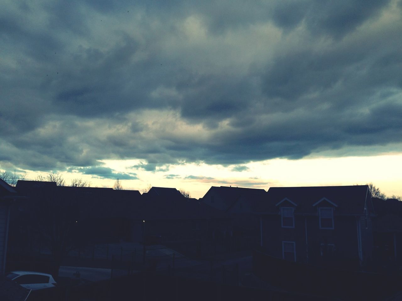 architecture, sky, built structure, building exterior, cloud - sky, cloudy, house, weather, low angle view, silhouette, overcast, residential structure, cloud, residential building, storm cloud, sunset, dusk, building, dramatic sky, outdoors