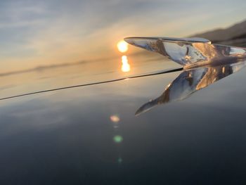 Close-up of sea against sunset sky