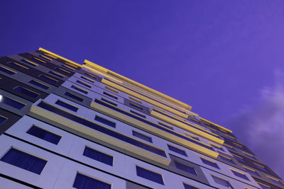 Low angle view of modern building against blue sky