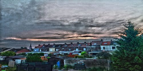 Buildings in city against sky at dusk