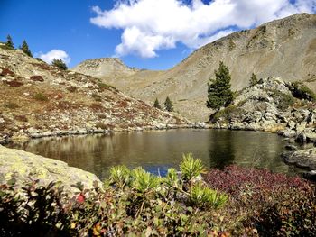 Scenic view of lake and mountains against sky