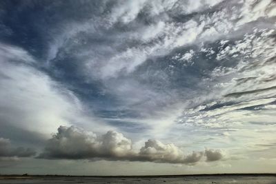 Scenic view of sea against storm clouds