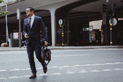 Full length of a man walking on road in city