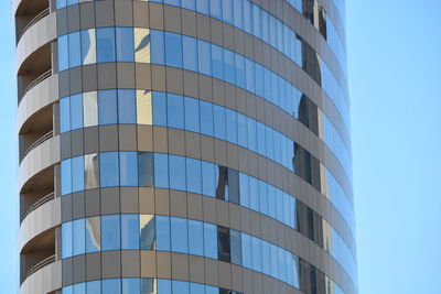 Low angle view of modern building against clear blue sky