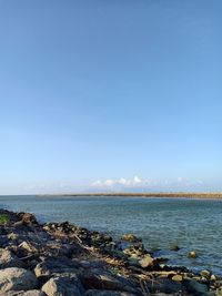 Scenic view of sea against clear blue sky