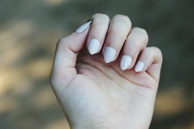 Cropped hand of woman with nail polish 