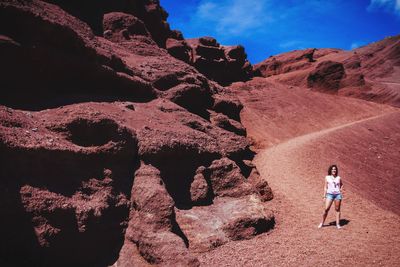 Full length of woman standing on rock formation