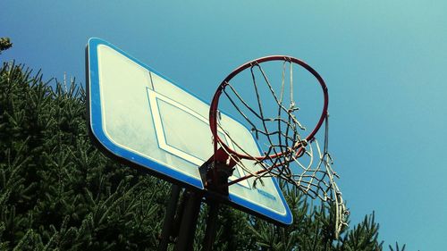 Low angle view of basketball hoop against blue sky