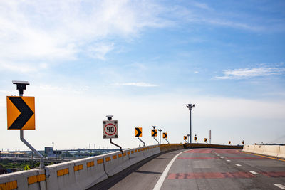 Road sign against sky