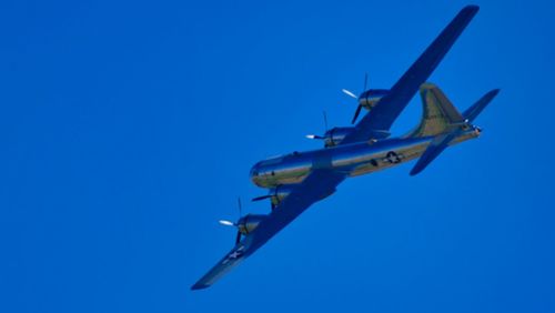 Low angle view of airplane against clear blue sky