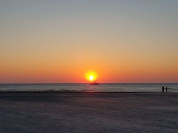 Scenic view of sea against clear sky during sunset