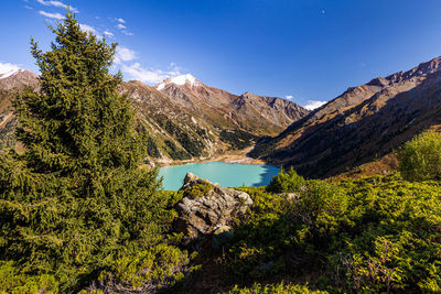 Scenic view of lake and mountains against sky