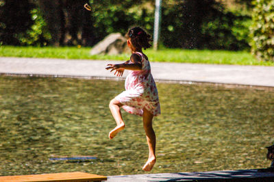 Full length of boy running on grass