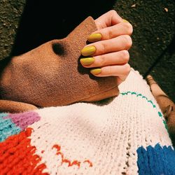 Cropped image of woman holding woolen textile