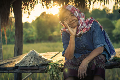 Portrait of smiling woman sitting in gazebo