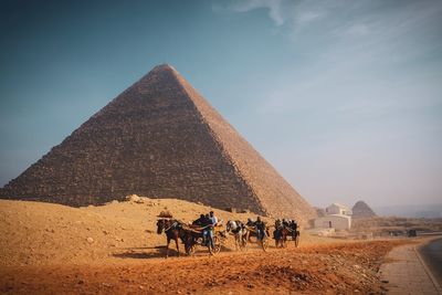 People riding horse in desert