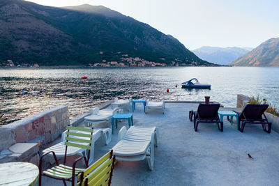 Sun loungers on a private dock with terrace . morning scenery of mountains and kotor bay