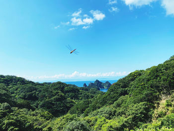 Scenic view of mountains against blue sky