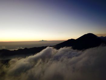 Scenic view of silhouette mountains against sky during sunset