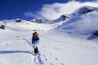 Full length of man walking on mountain in winter