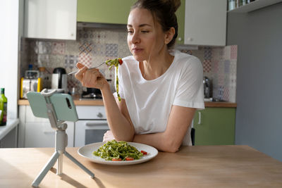 Woman having food at home