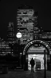 Full length of woman in illuminated city at night