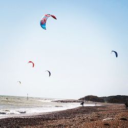Kite flying over beach against sky