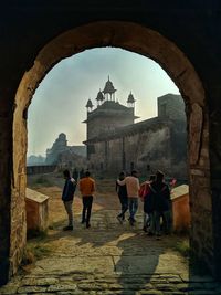 Rear view of people walking in historical building