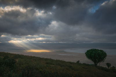 Scenic view of land against sky during sunset