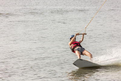 Woman kiteboarding in sea