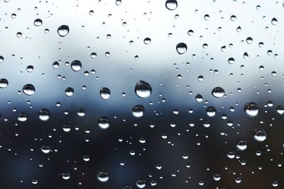 Full frame shot of wet glass window during rainy season