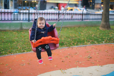 Full length of boy playing on slide at playground