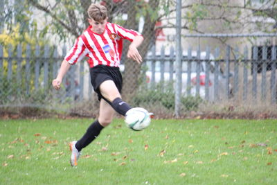 Woman playing soccer on field