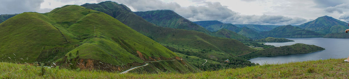 Scenic view of mountains against cloudy sky