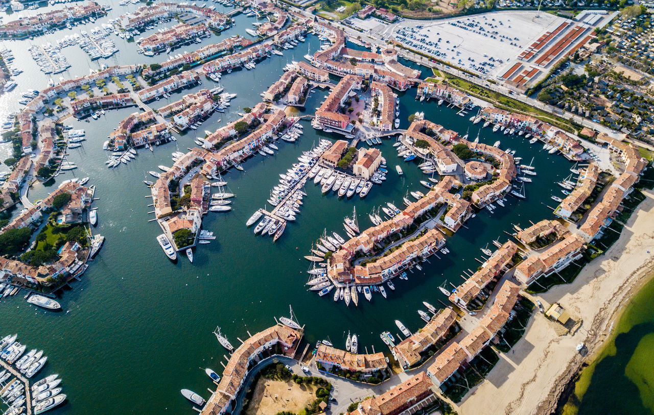 water, city, transportation, aerial view, architecture, high angle view, building exterior, built structure, nature, sea, nautical vessel, no people, day, travel destinations, cityscape, scenics - nature, mode of transportation, harbor, outdoors, sailboat