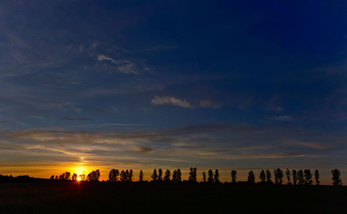 Silhouette buildings against sky during sunset