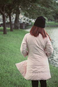 Rear view of woman standing on field