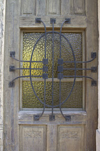 Close-up of metallic structure against window