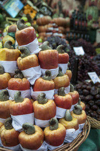 Close-up of cashew fruit with other fruits in market for sale