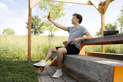 Full length of young woman exercising at park