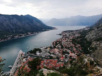 High angle view of sea and mountains against sky